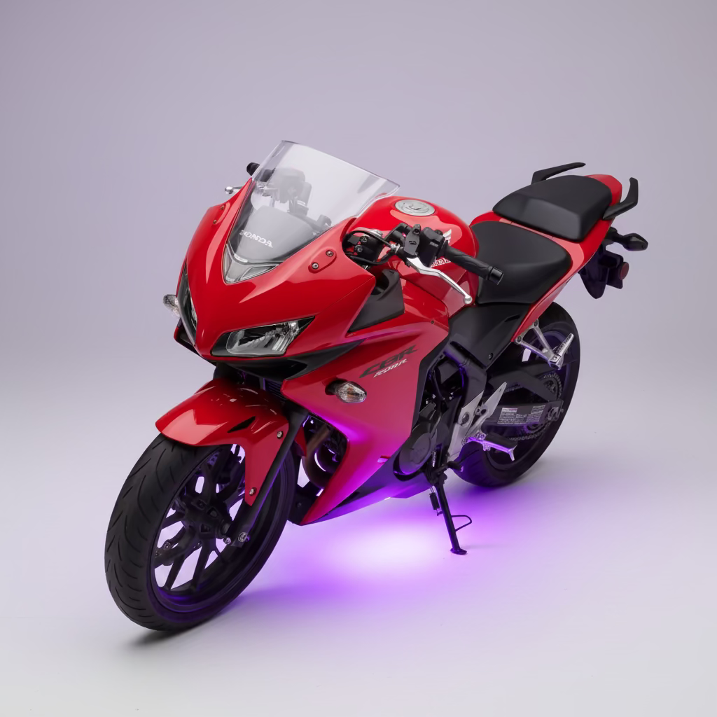 A red sport motorcycle with black seat and wheels, illuminated by purple LED underglow at night.